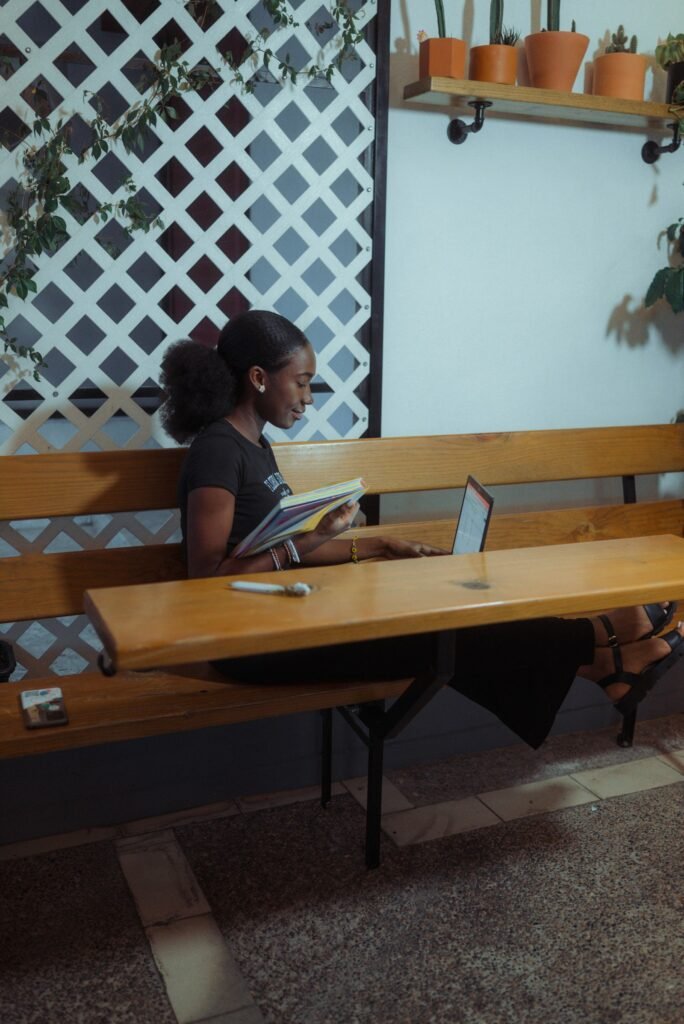 Person using a laptop and notebook while organizing keyword clusters by search intent